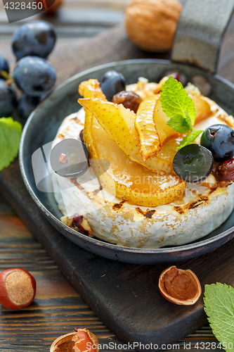 Image of Grilled cheese with pear and black grapes closeup.