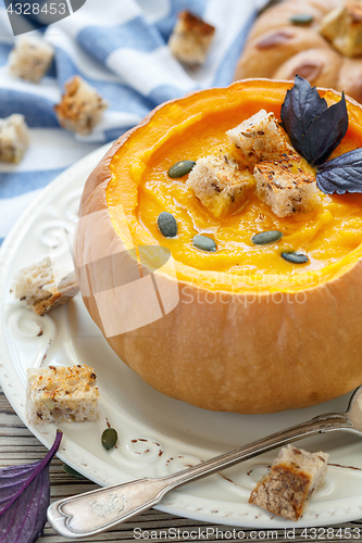 Image of Pumpkin soup with croutons in a pumpkin.