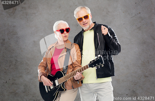Image of senior couple in sunglasses with electric guitar