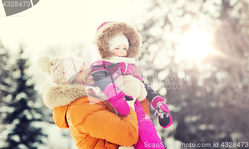 Image of happy family in winter clothes outdoors