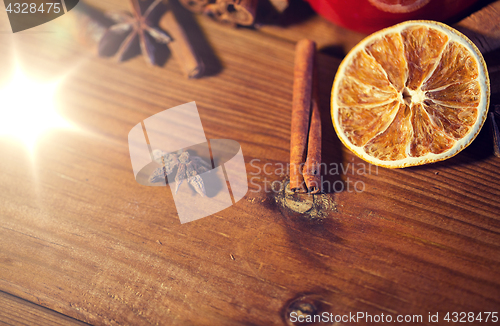 Image of cinnamon, anise and dried orange on wooden board