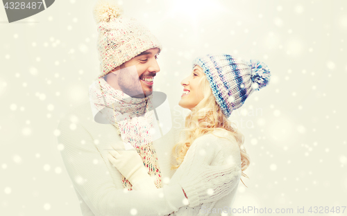 Image of smiling couple in winter clothes hugging