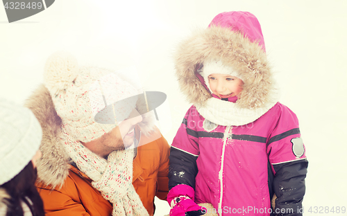 Image of happy family with child in winter clothes outdoors