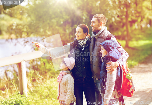 Image of happy family with backpacks hiking