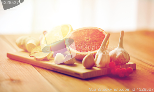 Image of citrus, ginger, garlic and rowanberry on wood