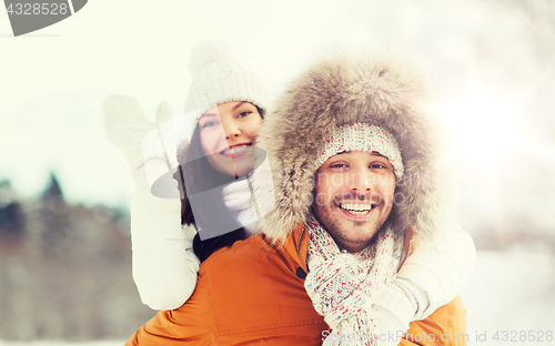 Image of happy couple having fun over winter background