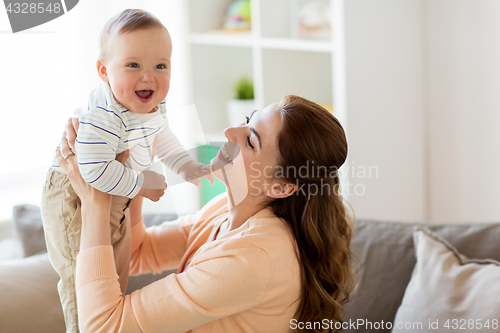 Image of happy young mother with little baby at home