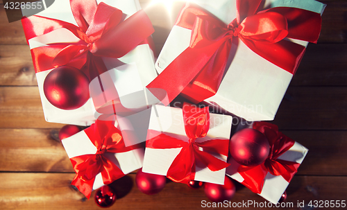 Image of close up of gift boxes and red christmas balls