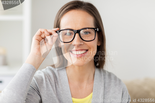 Image of happy smiling middle aged woman in glasses at home