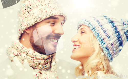 Image of smiling couple in winter clothes hugging