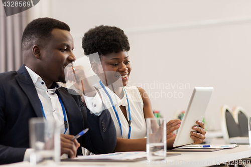 Image of team with tablet pc at business conference