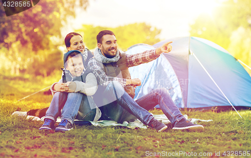 Image of happy family with tent at camp site