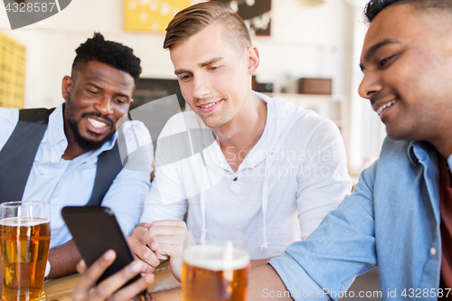 Image of male friends with smartphone drinking beer at bar