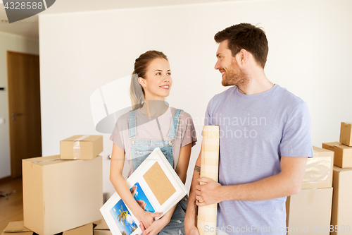 Image of happy couple with boxes moving to new home