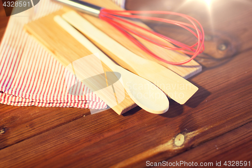 Image of close up of cooking kitchenware on wooden board