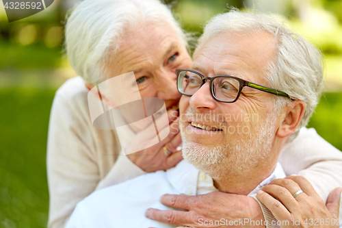 Image of close up of senior couple whispering outdoors