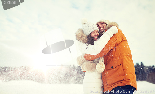 Image of happy couple hugging and laughing in winter