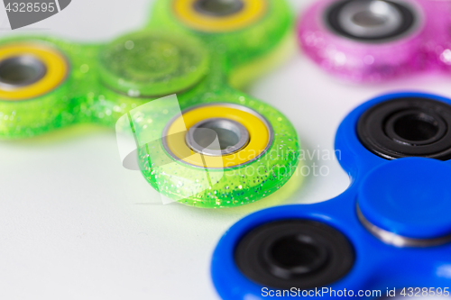 Image of close up of fidget spinners on white background