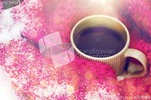 Image of close up of tea or coffee and winter scarf in snow