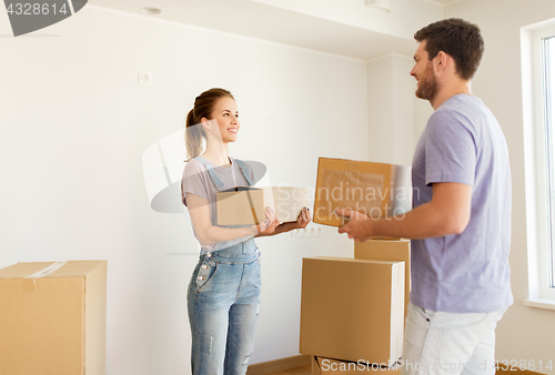 Image of happy couple with boxes moving to new home