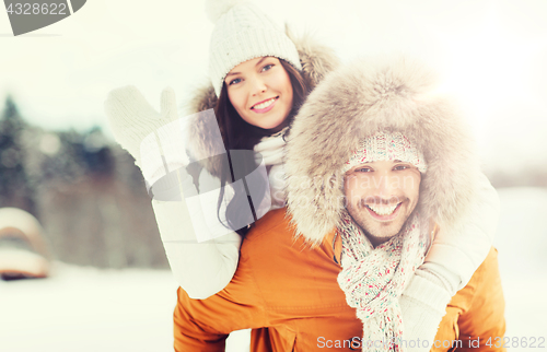 Image of happy couple having fun over winter background