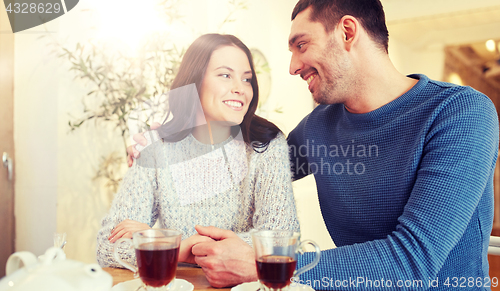 Image of happy couple drinking tea at restaurant