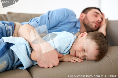 Image of happy father and son sleeping on sofa at home