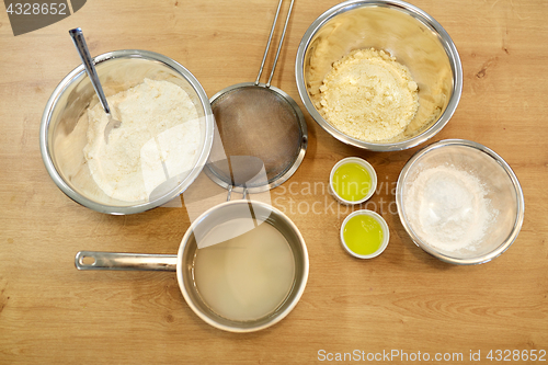 Image of bowls with flour and egg whites at bakery kitchen