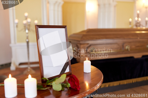 Image of photo frame and coffin at funeral in church