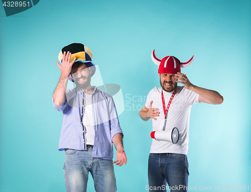Image of The two football fans over blue