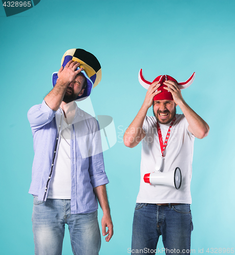 Image of The two football fans over blue