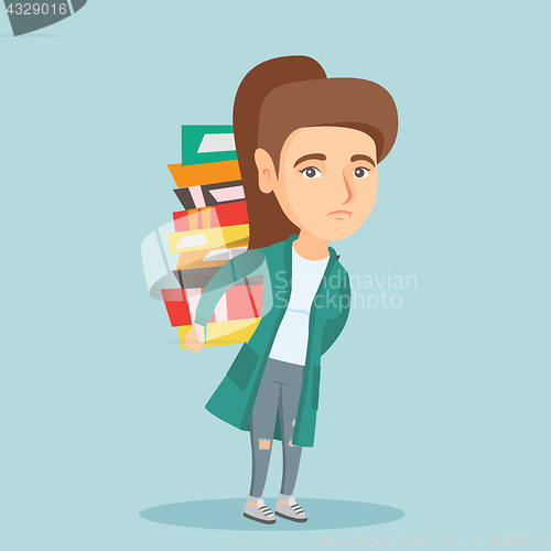 Image of Student carrying a heavy pile of books on back.