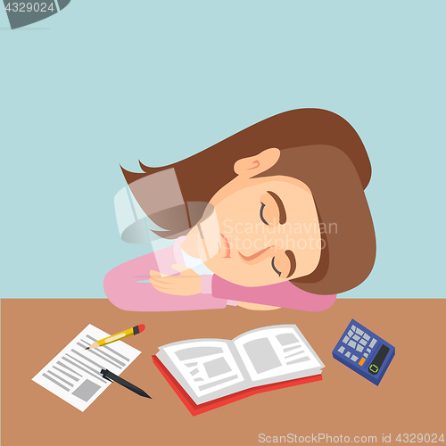 Image of Young caucasian student sleeping on the desk.