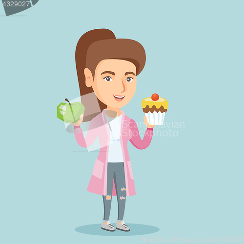 Image of Caucasian woman choosing between apple and cupcake
