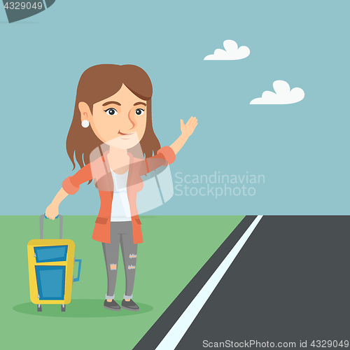 Image of Young caucasian woman with a suitcase hitchhiking.