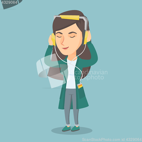 Image of Caucasian woman in headphones listening to music.