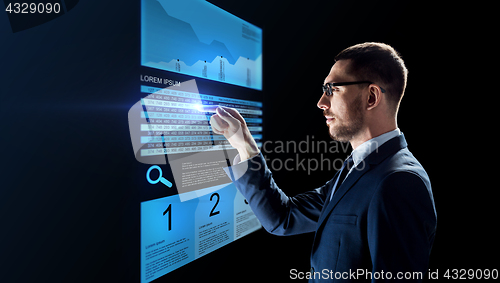 Image of businessman with stock charts on virtual screens