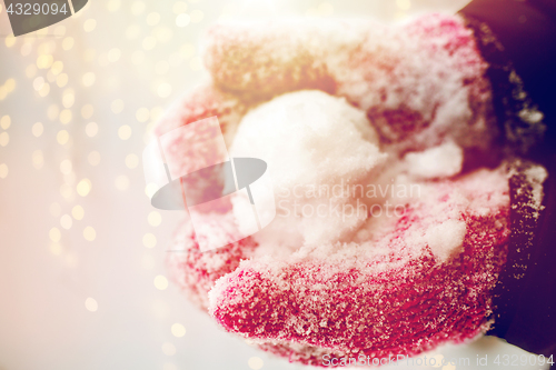 Image of close up of woman holding snowball outdoors