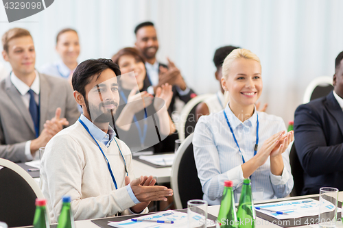 Image of people applauding at business conference