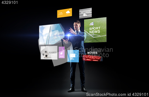 Image of businessman with applications on virtual screen