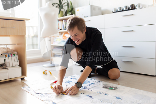 Image of fashion designer making dress at sewing studio