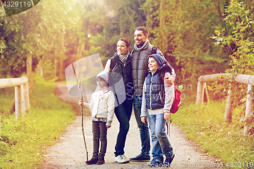 Image of happy family with backpacks hiking