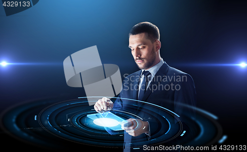 Image of businessman in suit with transparent tablet pc