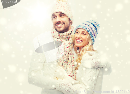 Image of smiling couple in winter clothes hugging