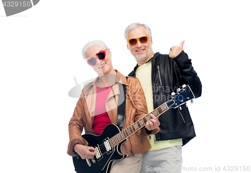 Image of happy senior couple with guitar showing thumbs up