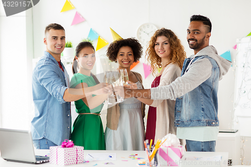 Image of happy team with champagne at office birthday party