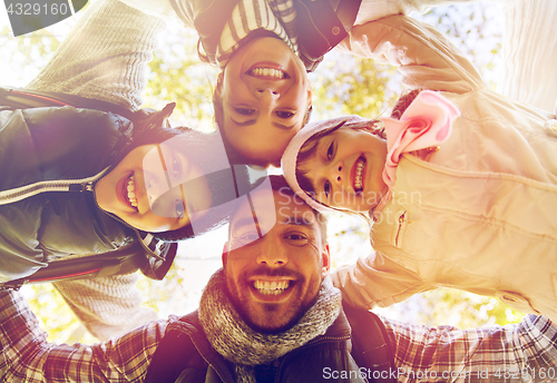 Image of happy family hugging outdoors