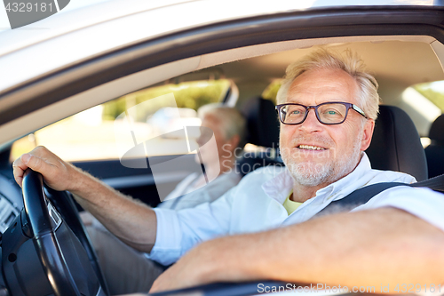 Image of happy senior couple driving in car