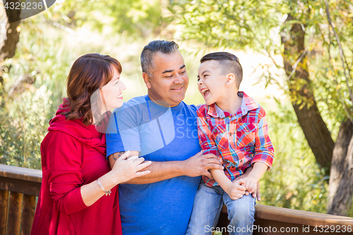 Image of Mixed Race Caucasian and Hispanic Family At The Park.