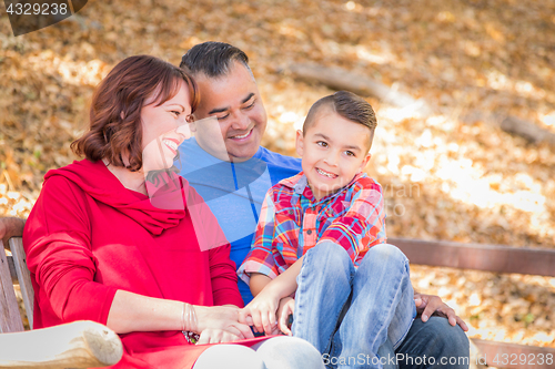 Image of Mixed Race Caucasian and Hispanic Family At The Park.